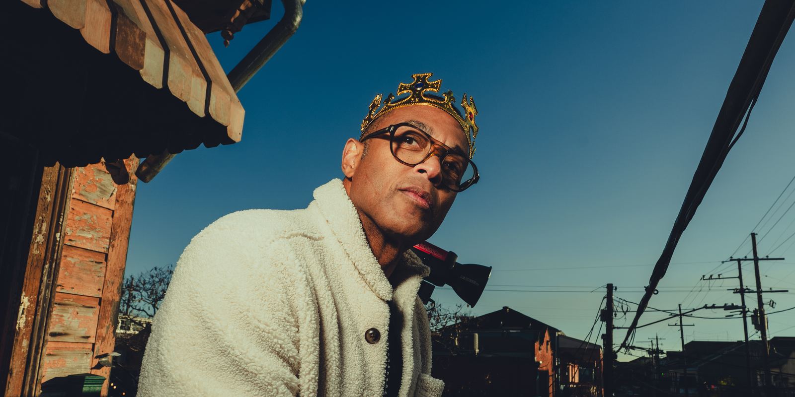 Don in a gold paper crown on a balcony above Frenchmen Street