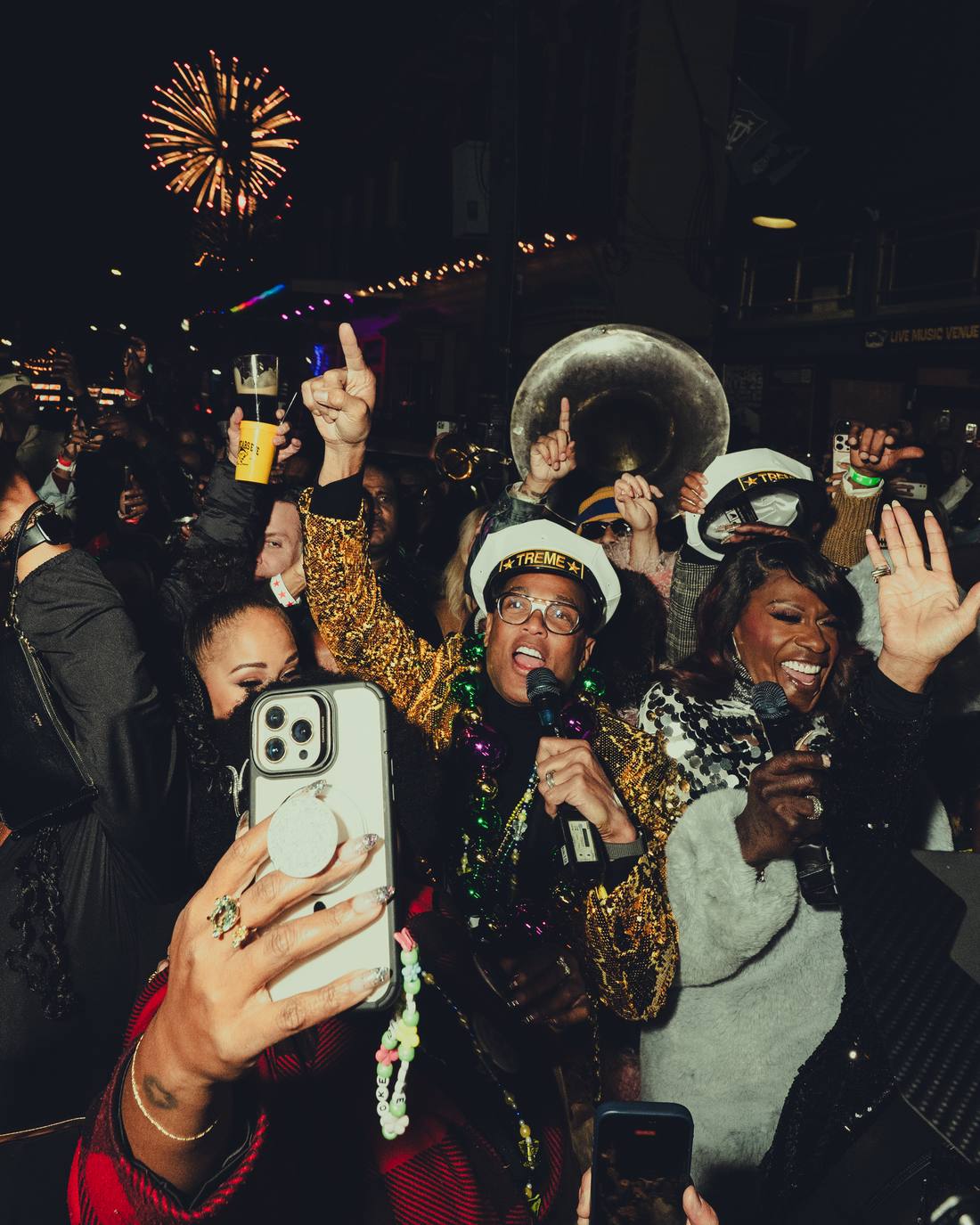 Don leading the crowd on Frenchmen Street as fireworks go off